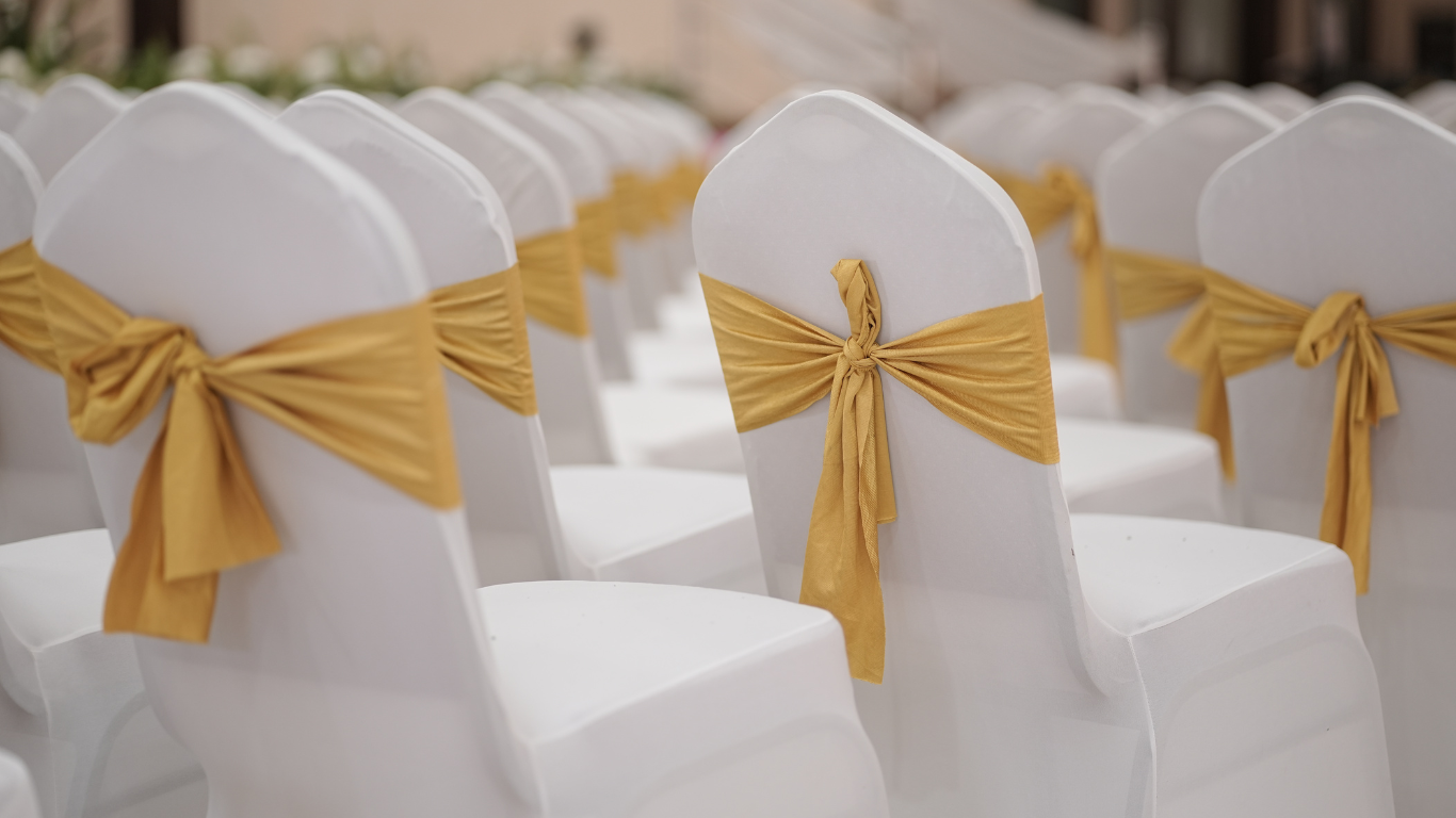 AJM chair ribbons adding a stylish, colorful accent to banquet seating for weddings and formal events