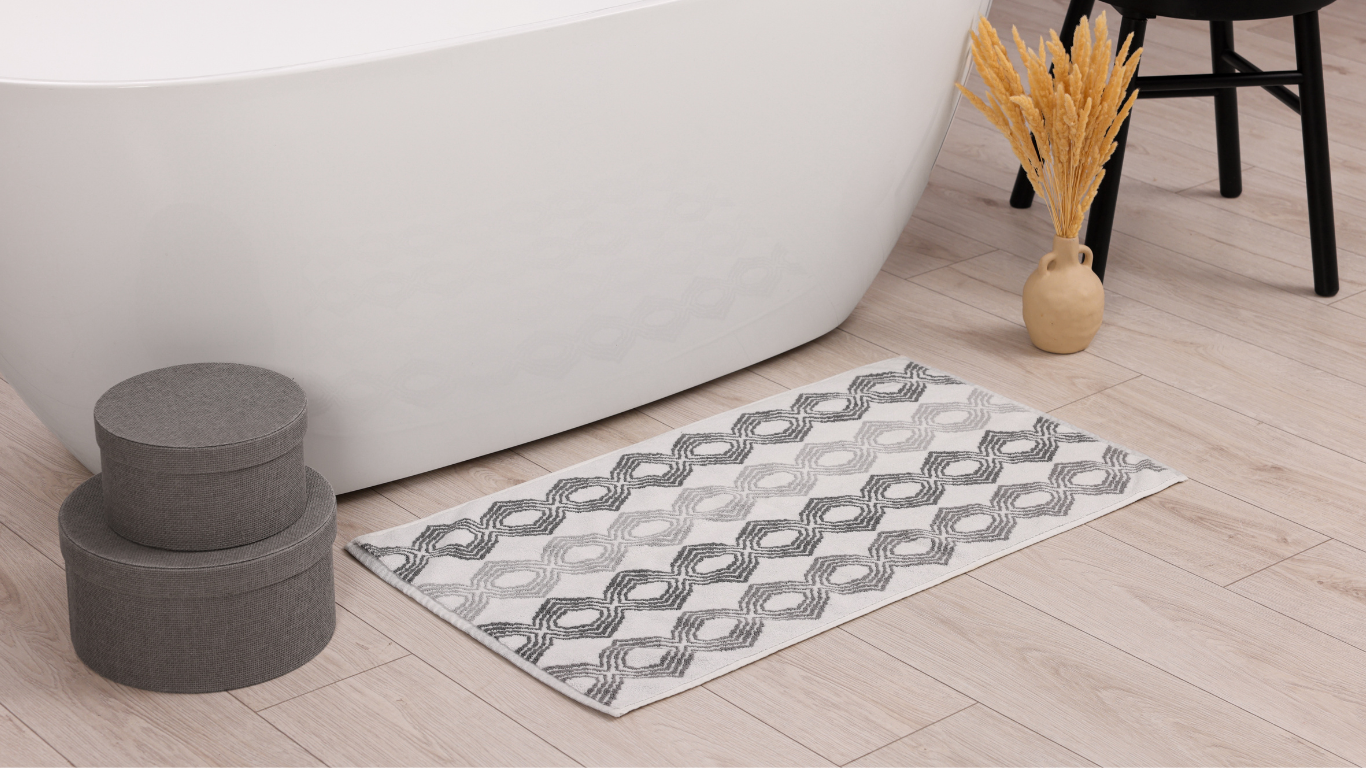 Heavy-duty cotton bath mat offering reliable grip and guest safety — ideal for high-traffic hospitality bathrooms.