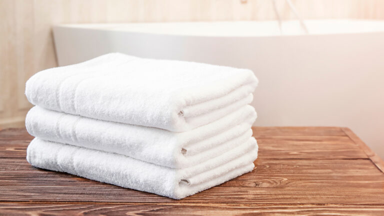 Plush white hotel bath towels made from premium ring-spun cotton — crafted by AJM Textiles for high absorbency, softness, and long-lasting comfort in hospitality settings.